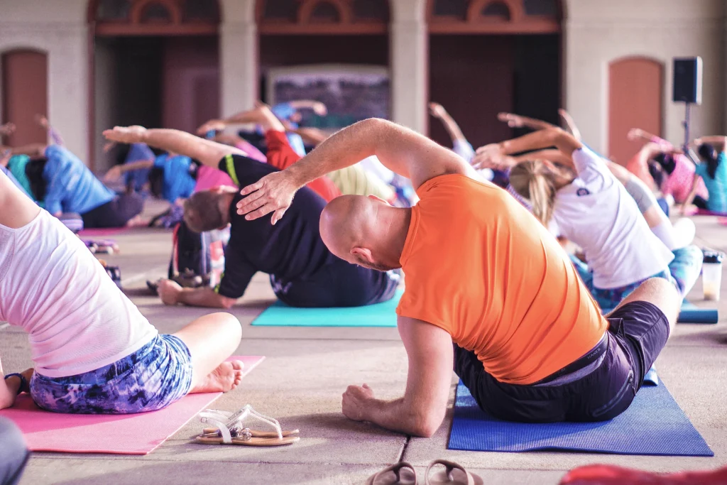 Group stretching in a class - Exploring Exercise and Workouts for Optimal Benefits.