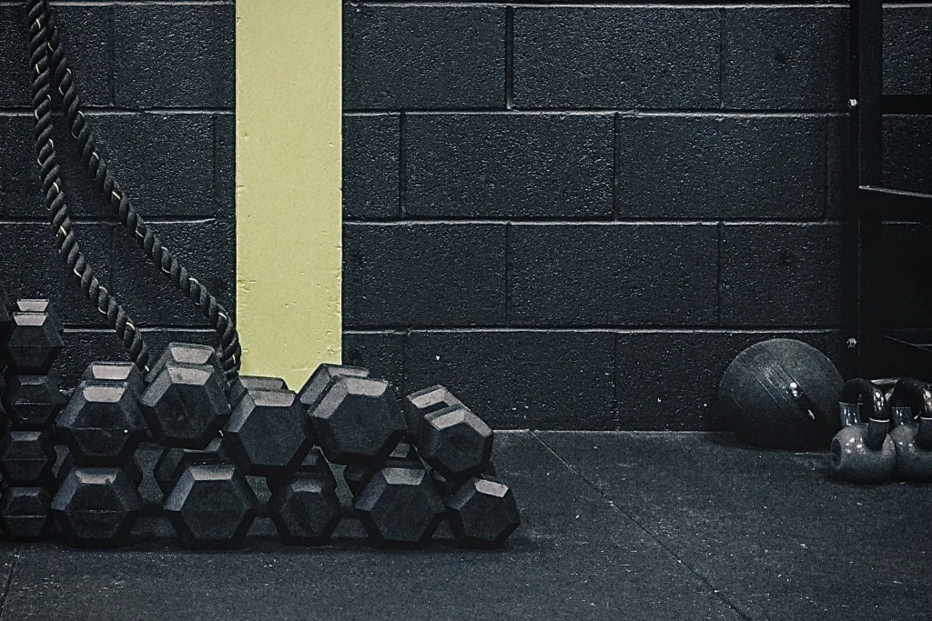 Dumbbells, ropes and kettlebells at one corner of gym