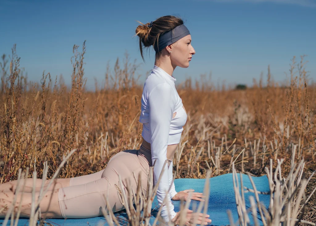 Girl performing Bhujangasana (Cobra Pose). Flexibility: benefits of Surya Namaskar