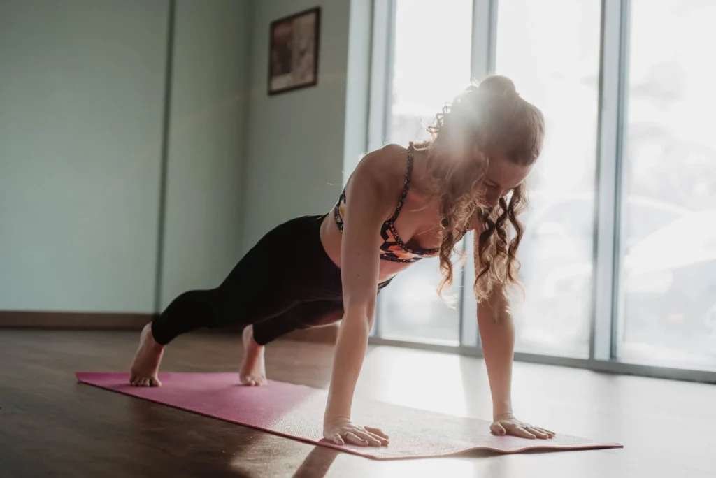 Woman doing push-ups, targeting chest, shoulders, triceps and core