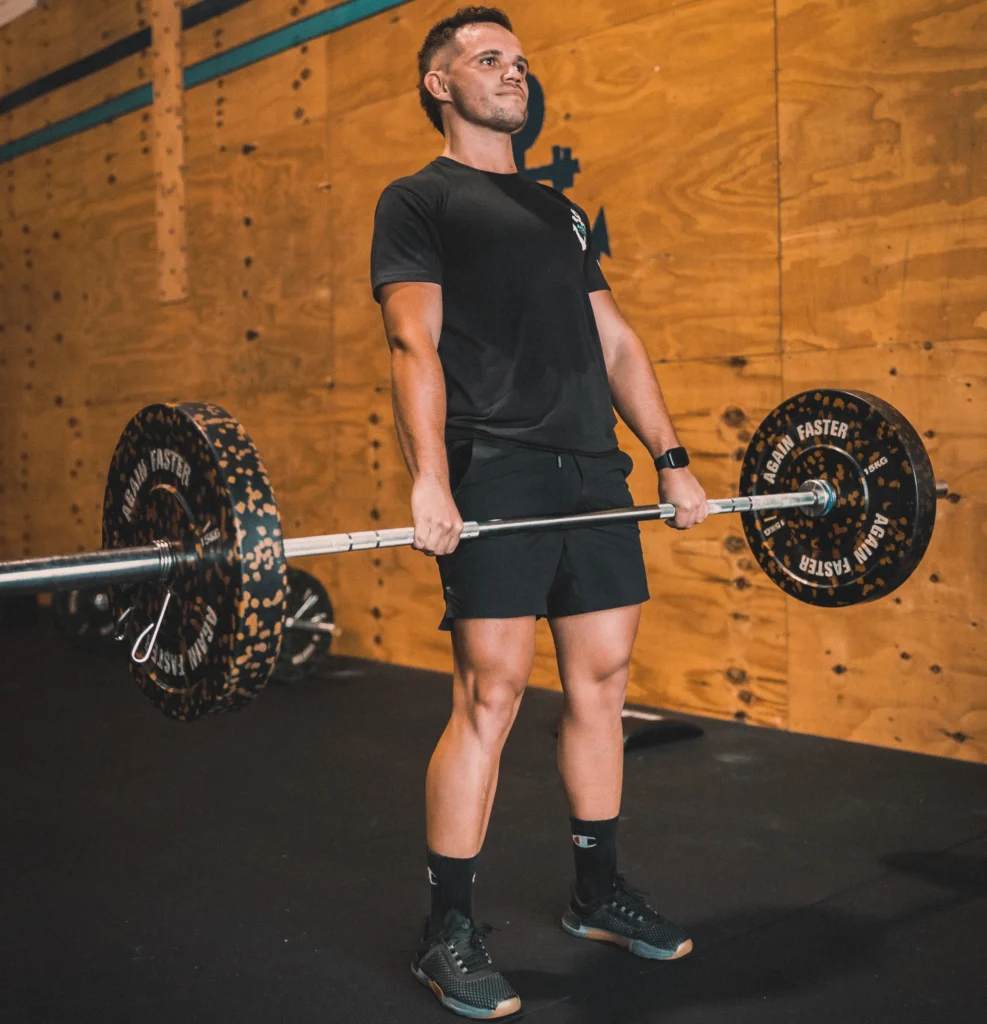 Boy demonstrates stiff leg deadlift, showcasing its benefits