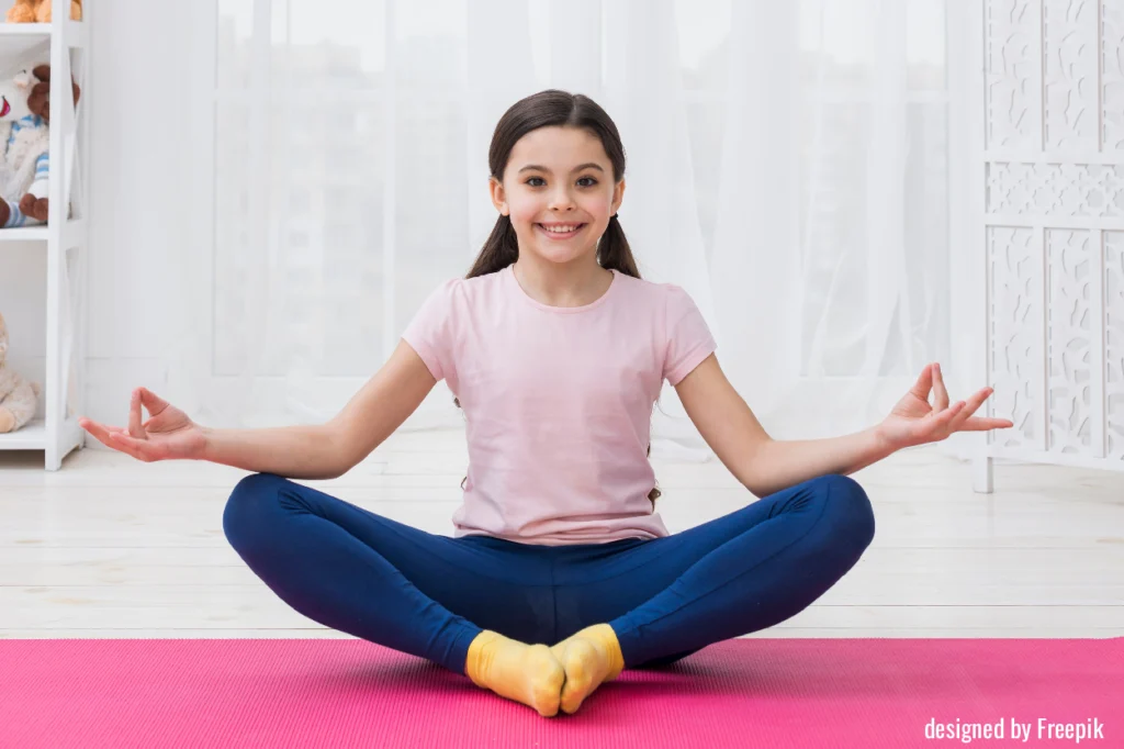 Elementary school student: girl performing yoga with a smile